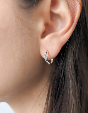 Елегантни дамски обеци с минималистичен дизайн във формата на преплетени халки или стилизиран символ на безкрайнос, изработени от сребро с проба 925