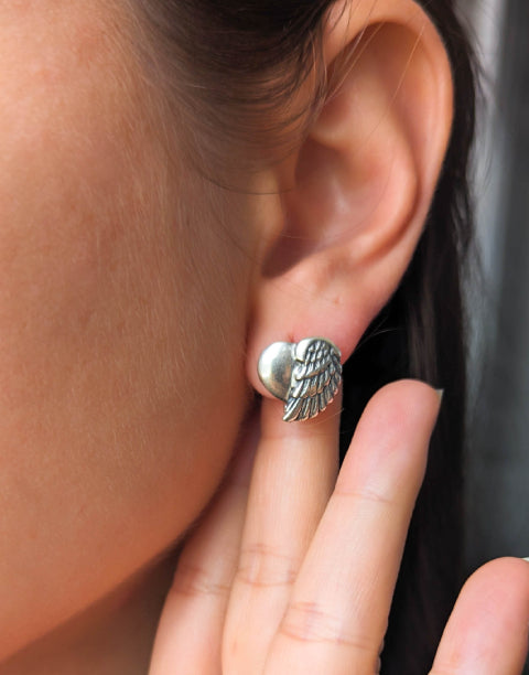 Сребърни обеци във формата на сърце с ангелски крила. Обеците са от сребро с проба 925.