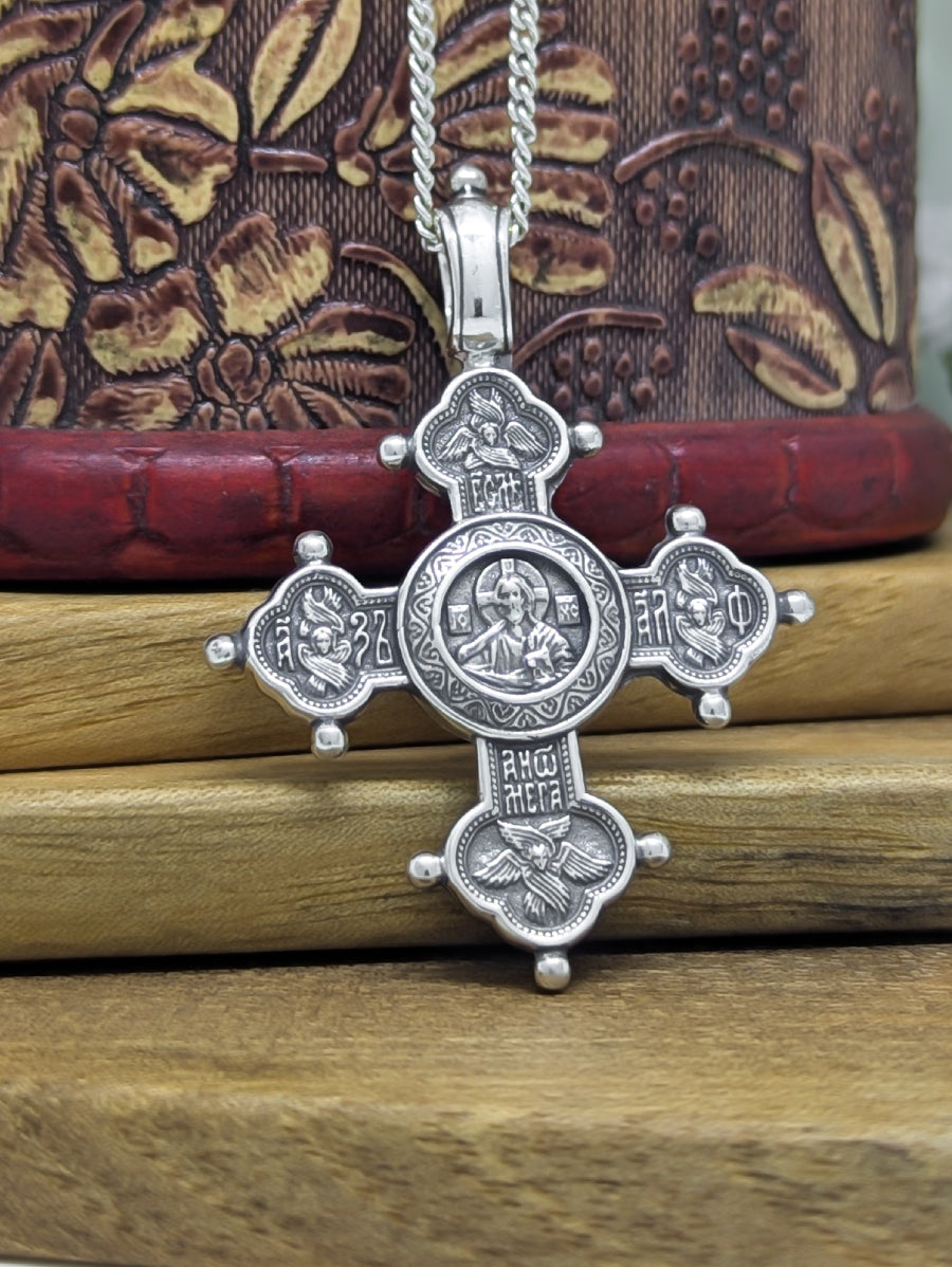 Сребърен православен кръст 925 с изображение на Иисус Христос Вседържител и релефни символи – лицева страна на двулицев медальон.