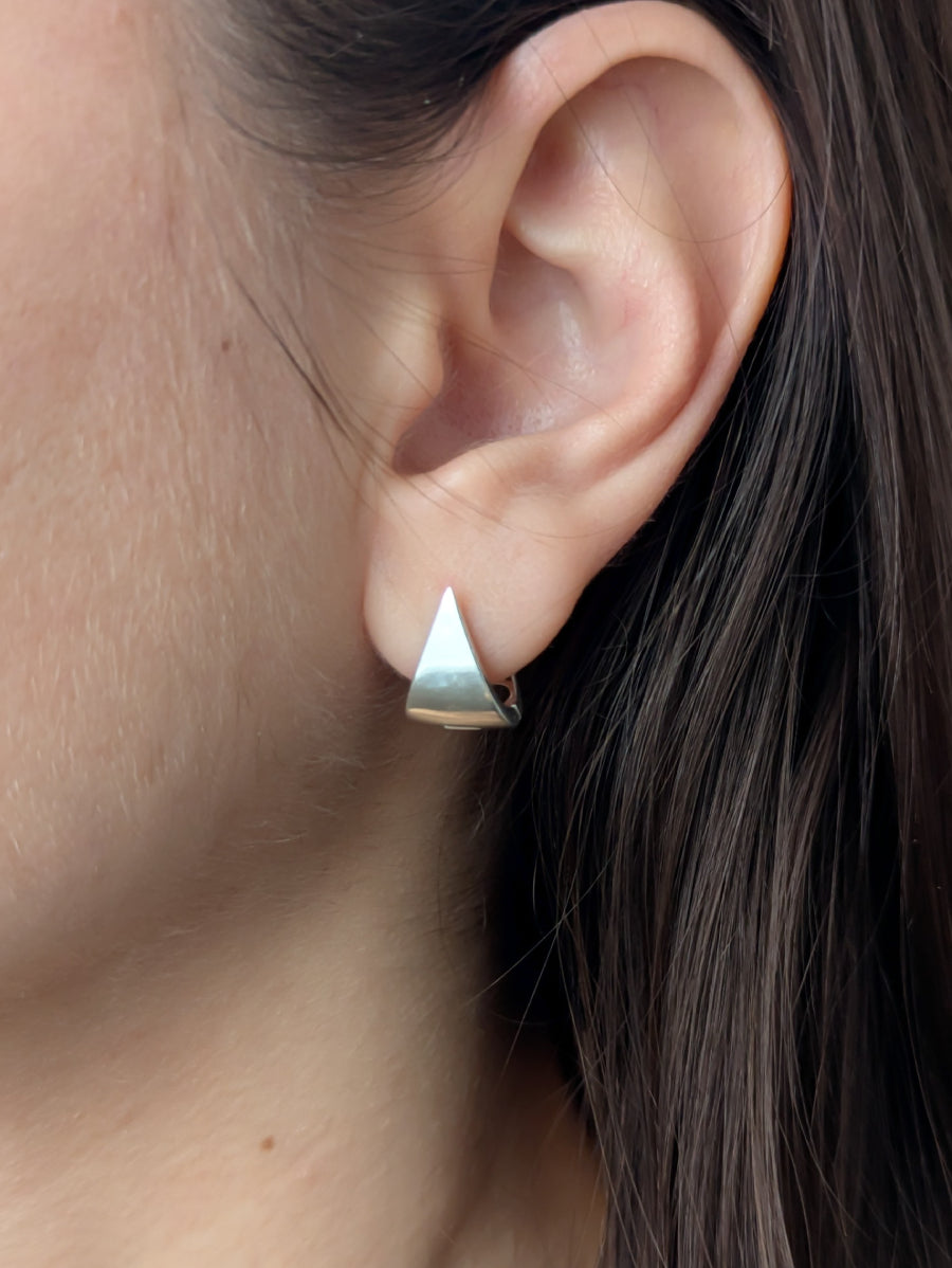 Сребърни триъгълни обеци с ажурна задна част, съчетаващи минимализъм и артистичен стил.